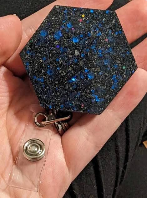 Black and blue glittering badge-reel