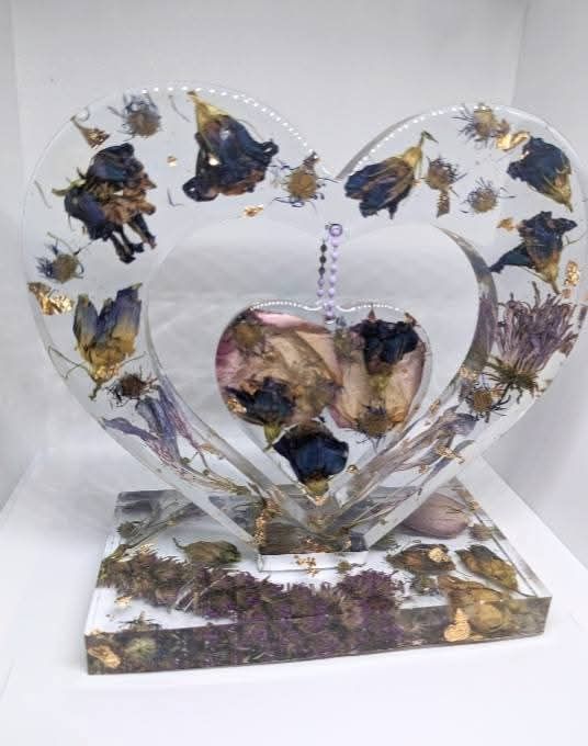 heart shaped epoxy peice with many flowers in it