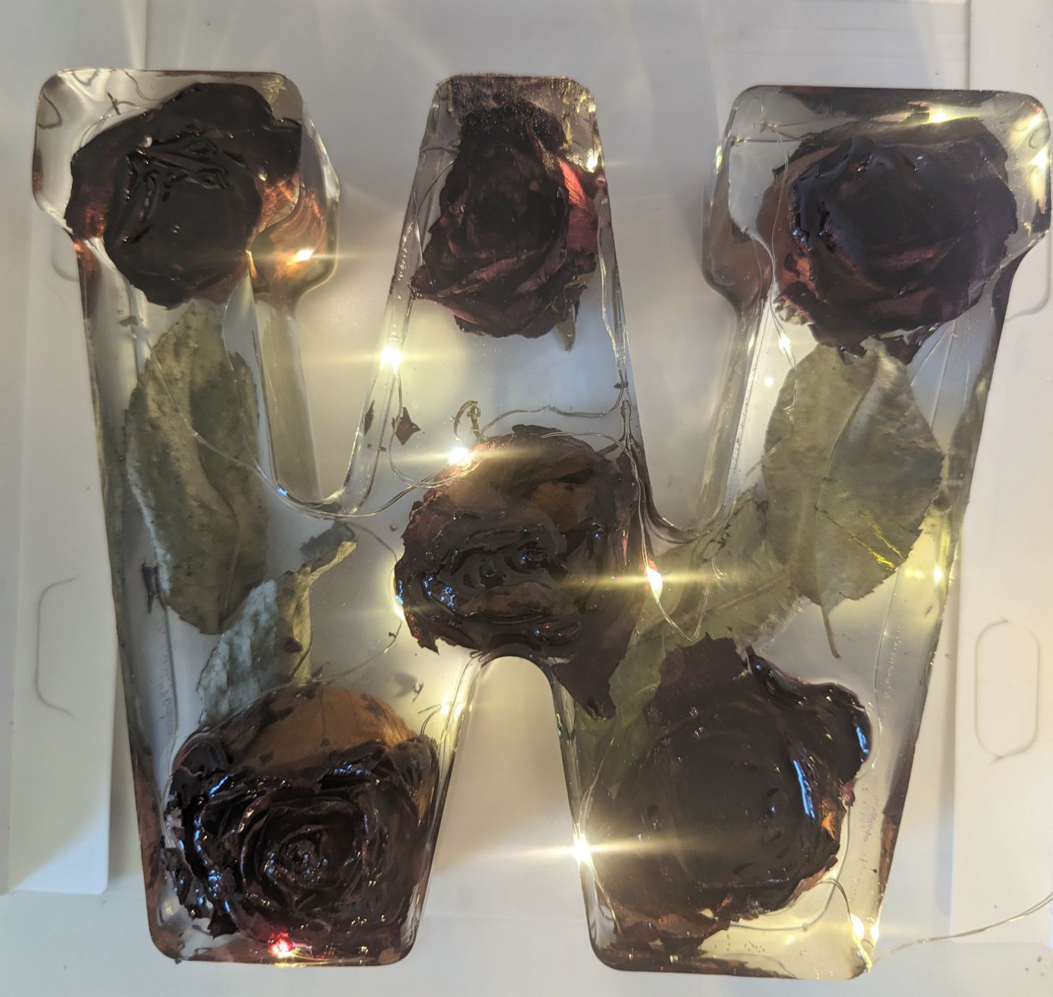 epoxy piece in the shape of a W with flowers