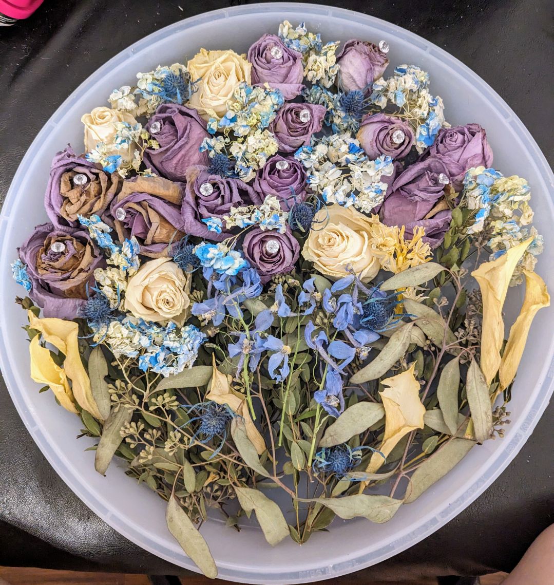 circular epoxy piece with blue, yellow, and purple flowers